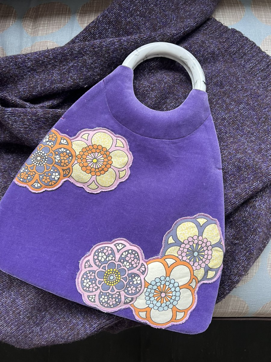 Handcrafted using traditional mosaic fabric-making techniques, this round-handled bag is a creation from Suzhou Cobblers.