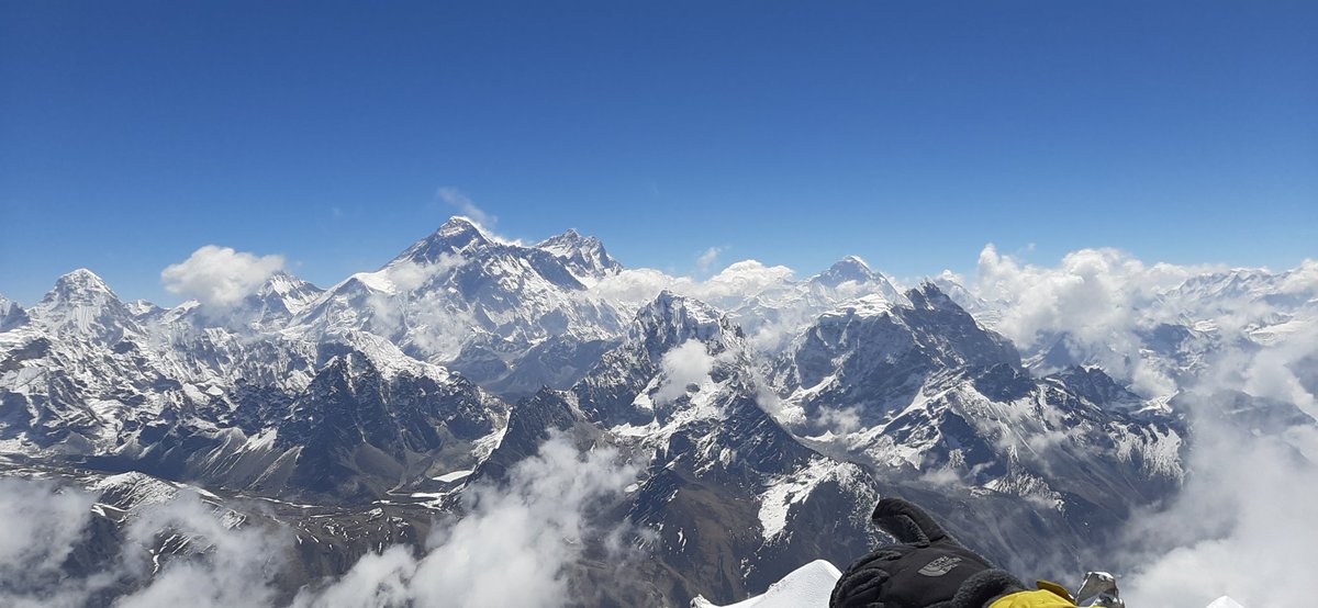 Endless sky, fresh wind, torn clouds covering the valleys and glaciers below, sharp mountain peaks rise above it all and a friend points with his hand to our next goal