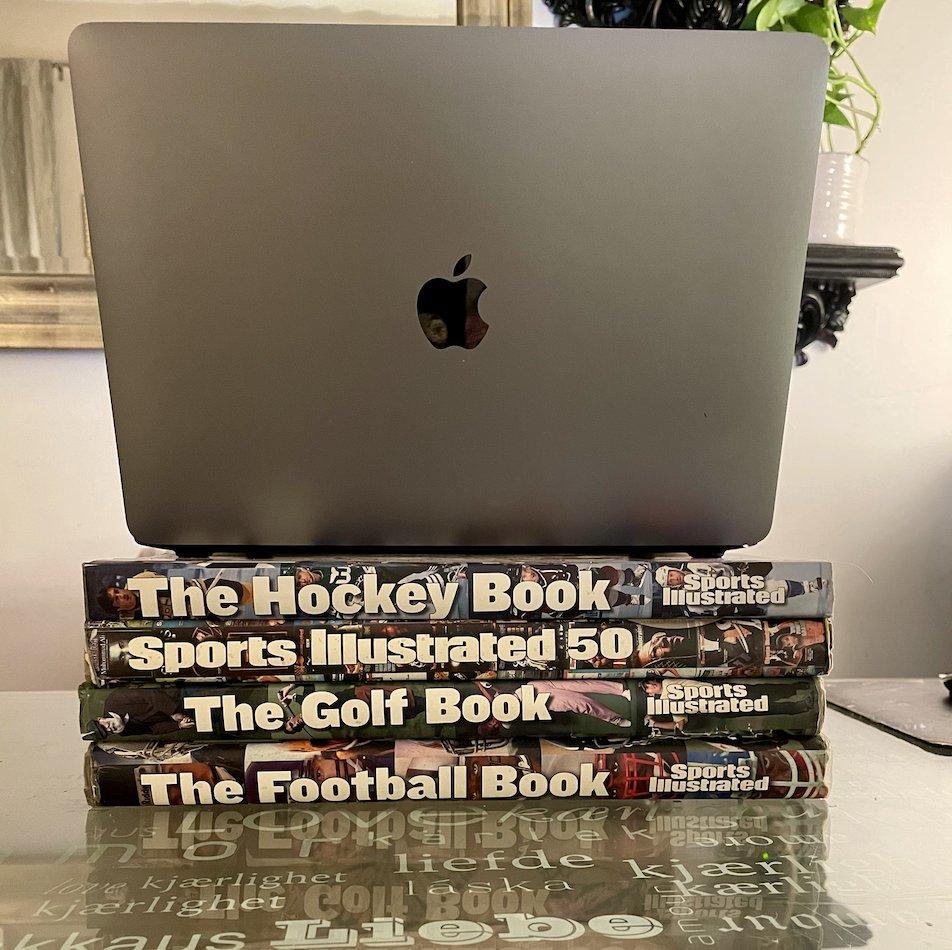Lisa_Altobelli's tweet photo. This hits home. I just looked down and realized I was typing on a stack of some of the Sports Illustrated books I worked on as a reporter there. Everything about today's news is equally maddening and heartbreaking. https://t.co/MuIbyjMo4L