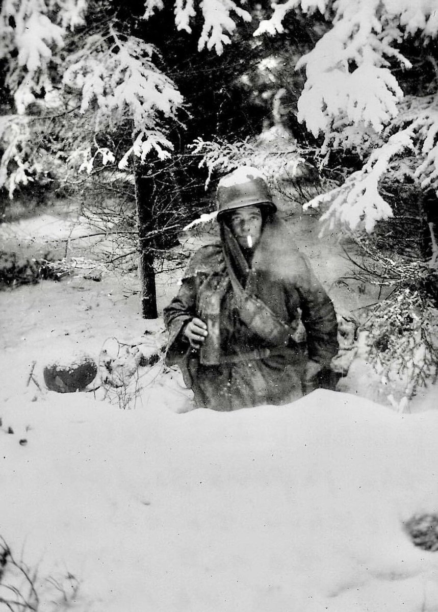 In January of 1945, Pfc. George Guckenberger of the 101st Airborne Division smokes in his foxhole near Bastogne. 🪖 He was killed in action on January 14, 1945 at the age of 22. 🪦