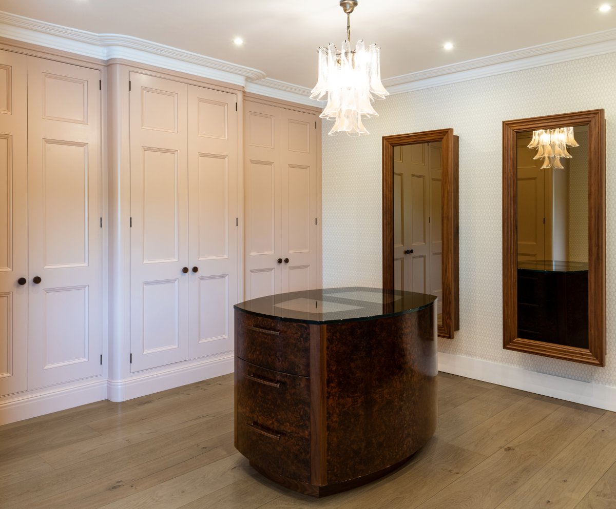 Project 3598. Timeless three-panel wardrobes hand painted in Farrow &amp; Ball Setting Plaster. #dressingroomdesign #dressingroomfurniture #ultimatedressingrooms #bespokedressingrooms #dressingroomdesigners #bespokebedrooms #bedroomfurniture #handmadebedrooms #bedroomdesign