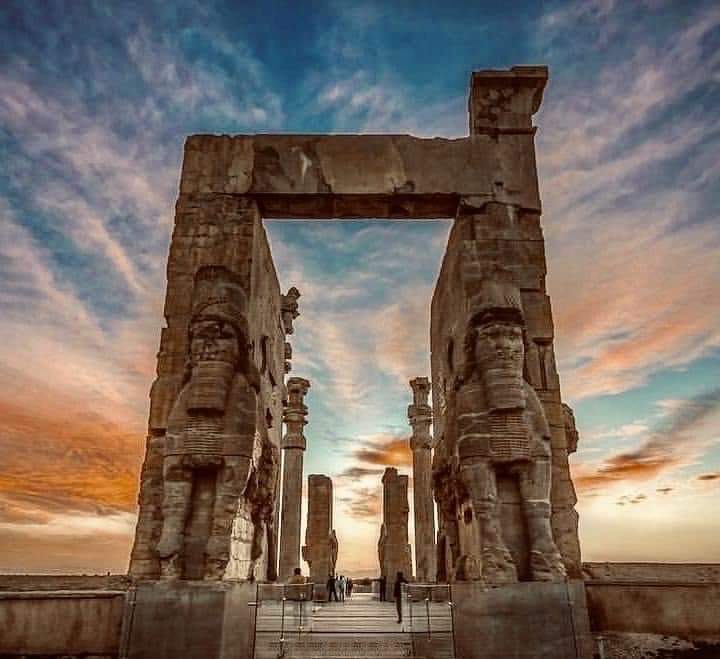 archeohistories's tweet photo. The Gate of All Nations, also known as the Gate of Xerxes, is located in the ruins of the ancient city of Persepolis, Iran. The construction of the Staircase of the Nations and the Gate of the Nations was ordered by the Achaemenid king Xerxes I (486-465 BC), successor of Persepolis' founder Darius I.

The Gate of all Nations consisted of a grand hall that was a square of approximately 25m in length, with four columns and its entrance on the Western Wall. Xerxes’s name was written in three languages (Old Persian text are Babylonian and Elamite) and carved on the entrances, informing everyone that he ordered it to be built. It translates as; ‘A great god is Ahuramazda, who created this earth, who created heaven, who created man, who created happiness for man, who made Xerxes king, one king of many kings, commander of many commanders’.

The structure consisted of one large chamber, the roof of which was supported by four stone pillars with bell-shaped bases. This room had a stone bench running parallel to the inner wall, interrupted by the doorway. The outer wall, made of wide mud blocks, had numerous gaps. Each of the three east, west, and south walls had a very large stone entrance. Two huge bulls secured the western entrance. Two Assyrian lamas stood at the eastern doorway, albeit gigantic. On top of each of the four colossi are trilingual inscriptions attesting to construction and completion of the gate by Xerxes. The southern doorway opens onto the Apadana and is the widest of the three doorways. Rotating devices in the inner corners of all the doors indicate that they had two doors covered with metal sheets, probably wooden and decorated.

Lamassu or bull-men originated in Babylonia and Assyria, but the Persians adopted them. These mythological creatures have the head of a bearded man. Lamassu is a winged animal with the head of a human. Assyrians used to place these figures at the entrance of the cities and palaces. In the past, visitors didn’t have much respect for these monuments and they left their marks on the walls of the Gate of All Nations. Many Iranians believe that these creatures were defaced by the Arabs when they conquer Persia in 7th Century CE.

📷 : Credit to the Owner

#archaeohistories