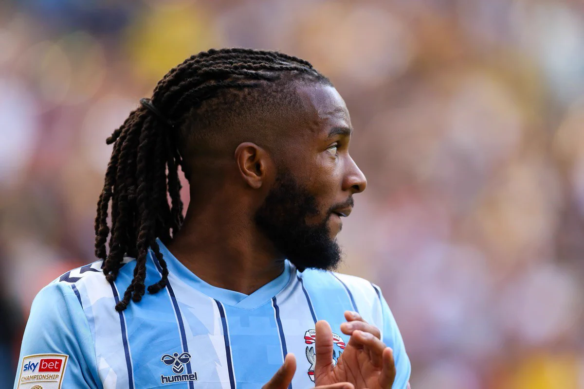 Kasey Palmer clapping, wearing our 23-24 home shirt.
