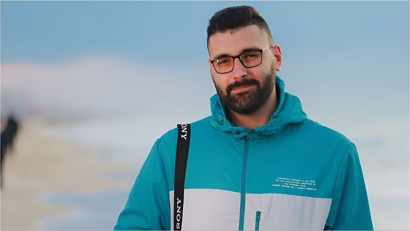 Motaz Azaiza (he/him) - @azaizamotaz9 - is a photographer best known for capturing life in the Gaza Strip. He works for the UNRWA. His photo titled "Seeing Her Through My Camera" (depicting a girl being picked up from rubble) was named one of TIME's top 10 photos of 2023.