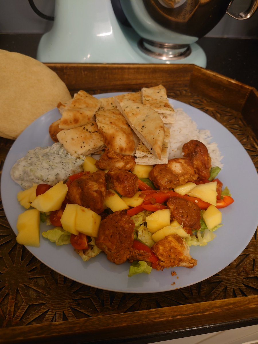 Homemade chicken tikka with a mango salad, rice and naan. And homemade raita to go with. I couldn't manage most of the naan