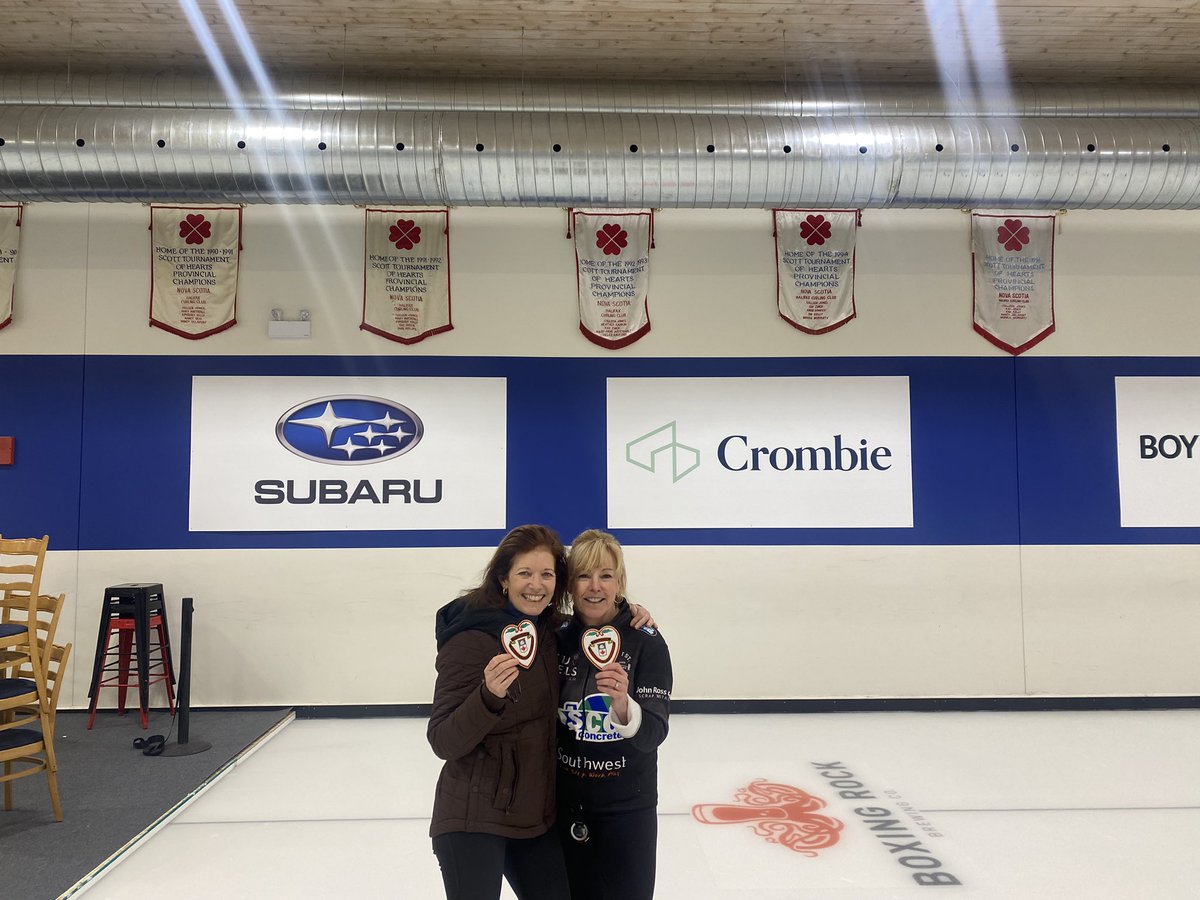 With my long time curling roommate Kim Kelly-underneath some of our old banners--
Now a different heart for both of us to add to our hearts collection--a coach's heart.