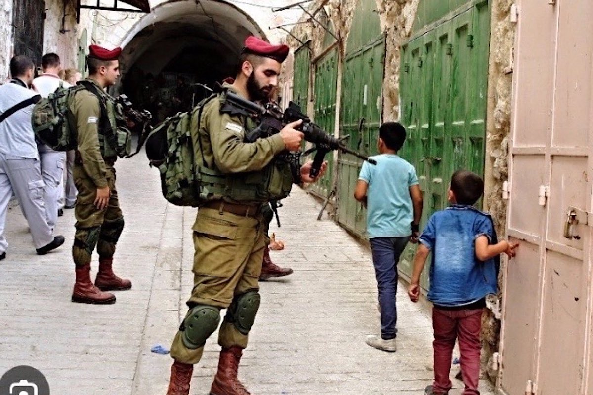 Resist_05's tweet photo. Zionist soldier points his gun at a Palestinian child’s head… this isn’t normal human behaviour…🇵🇸💔 https://t.co/hAq8ppG3X9