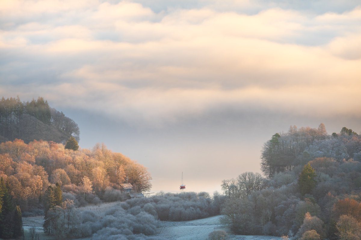 Looking down to a foggy Windermere, a lone yacht sits on the shoreline. #lakedistrict #wexmondays