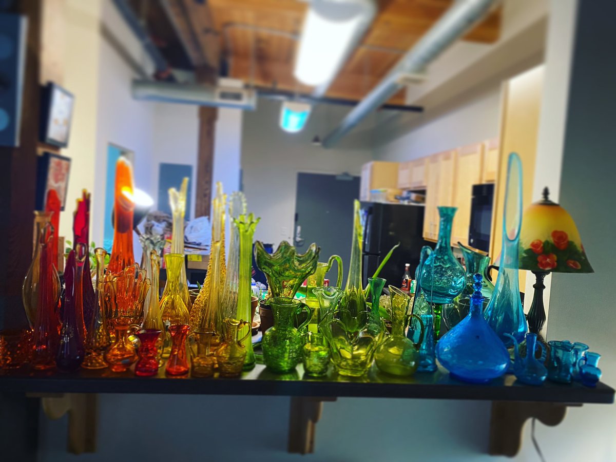 MadPlantLady's tweet photo. This week I unpacked my late father’s glassware collection. I was not prepared for how it would rip my heart out all over again. I put them in the same color gradient order that he did. Aren’t they beautiful 😭 #grief #vintageglass https://t.co/krEdwHPnKf