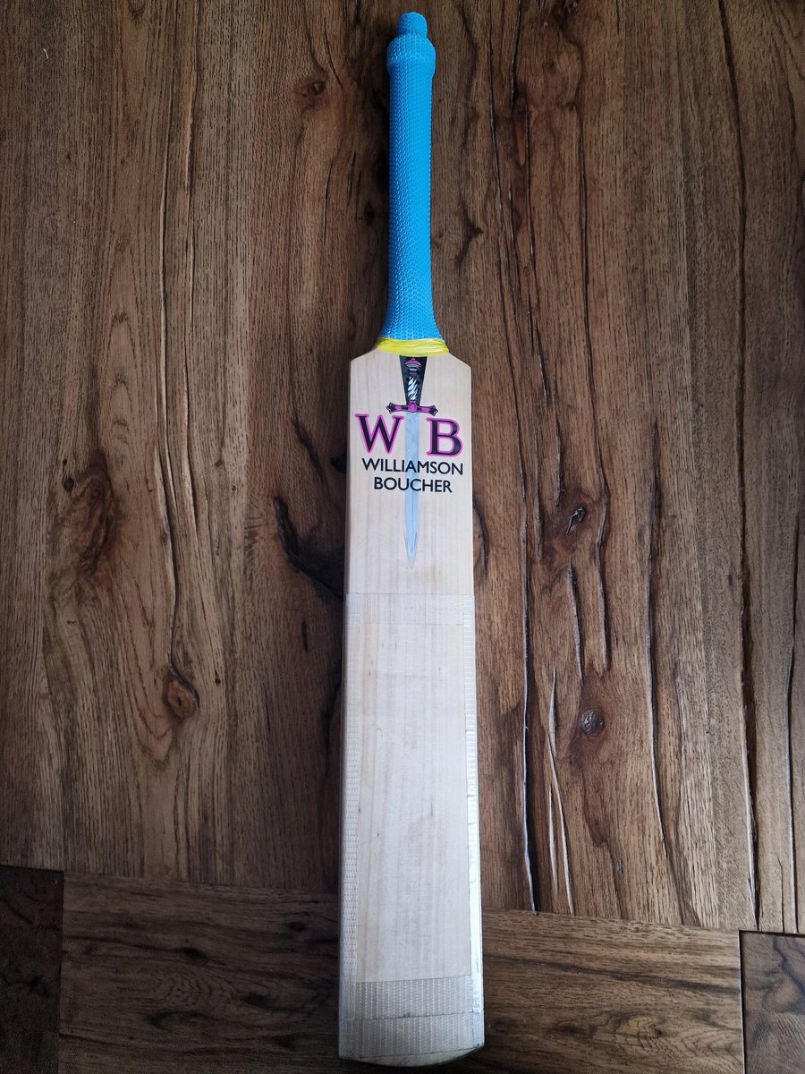 NBCCCIC's tweet photo. NBCC blue grip on my favourite Williamson Boucher (@BoucherCricket) bat. Really like the way it works with the yellow tape (indicates a match day bat) and the pink logo. https://t.co/Xby07Ga6Ny