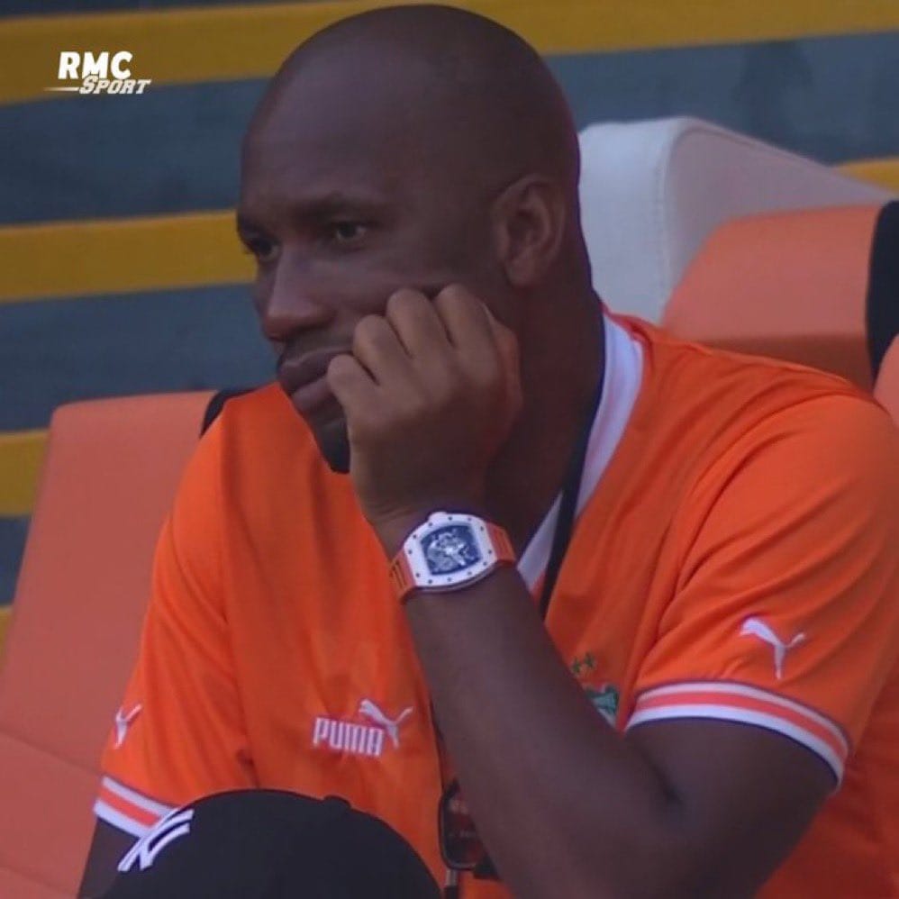 Drogba supports Ivory Coast and Chelsea, no wonder he has lost all his hair.