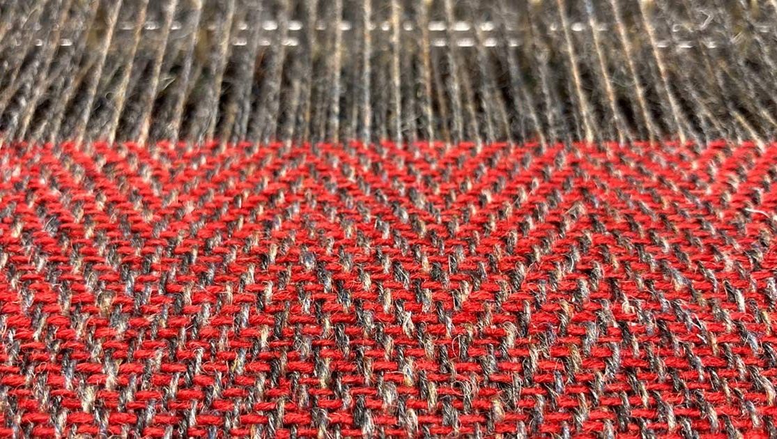 SkyeWeavers's tweet photo. First results of all that warping - Red Herringbone Tweed on the loom. #madeinscotland #skyeweavers #isleofskye https://t.co/jfIkYcSRwa