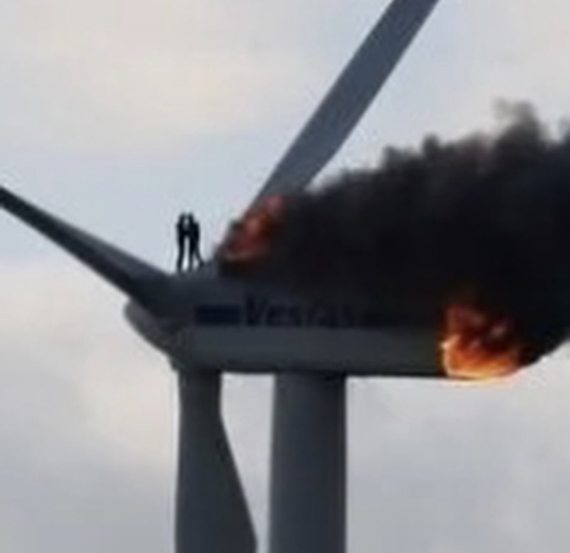 This picture tells the story of two engineers trapped on top of a wind turbine that’s on fire. Here they hug each other for a last time; one jumped, one burned.