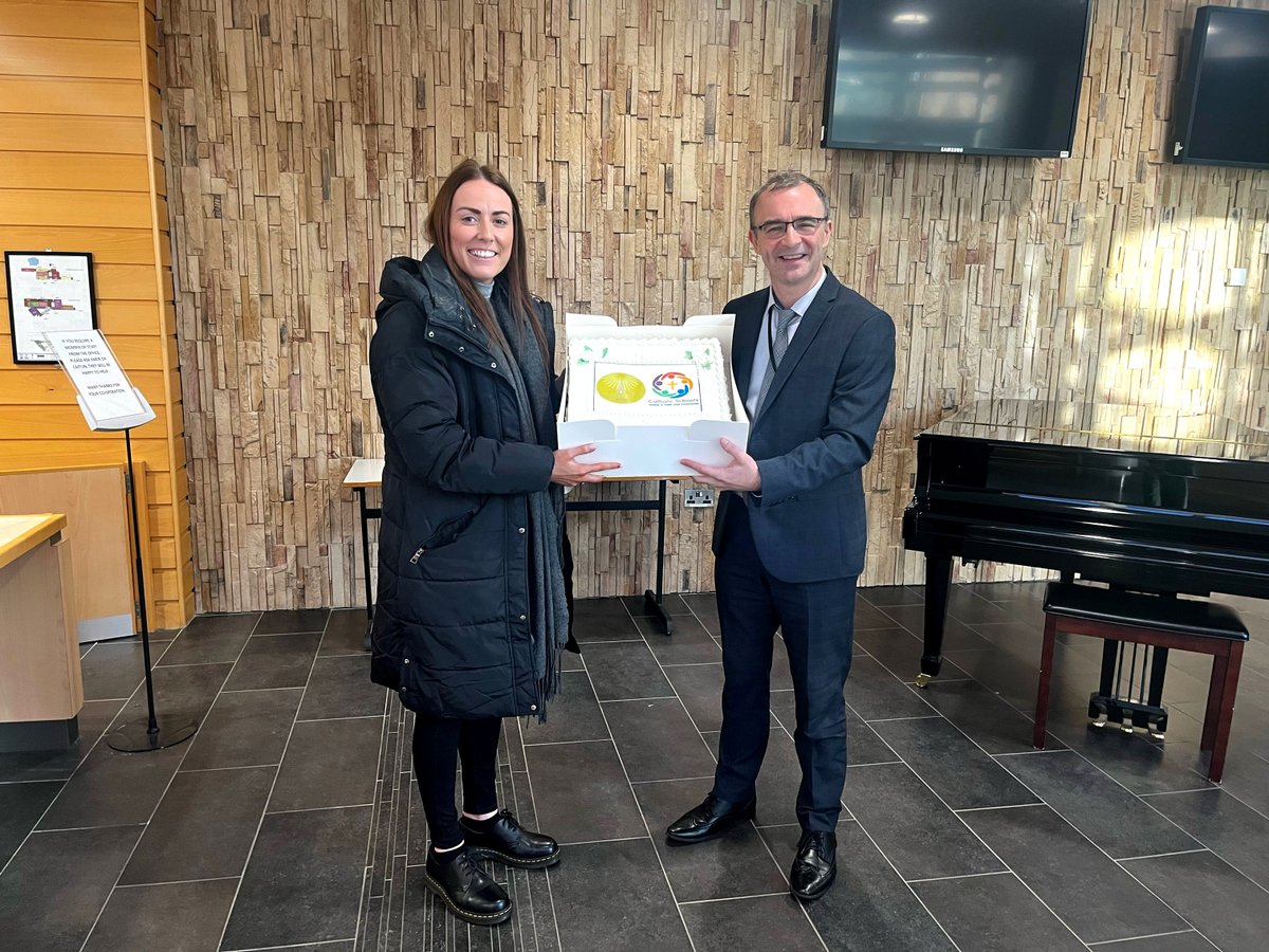 Lauren Doherty representing the Derry Catechetical Centre presenting a beautiful cake to Brendan McGinn (Principal) to mark Catholic Schools' Week.