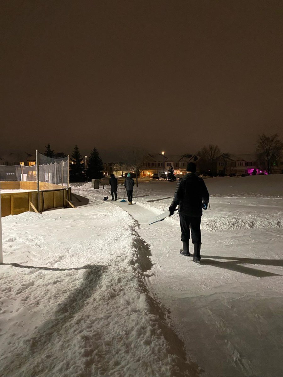 Dedicated volunteers scraping both main and puddle rink this evening so the ferocious freezing rain will not create too many bumps and we will have better edges since kids can’t lift snow over the boards yet ;)