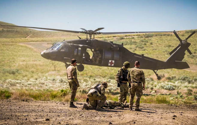 U.S. Army Capt. Danielle McDermott performs a medical evacuation scenario in the field with a medevac team. (Photo credit: Courtesy of Capt. Danielle McDermott).