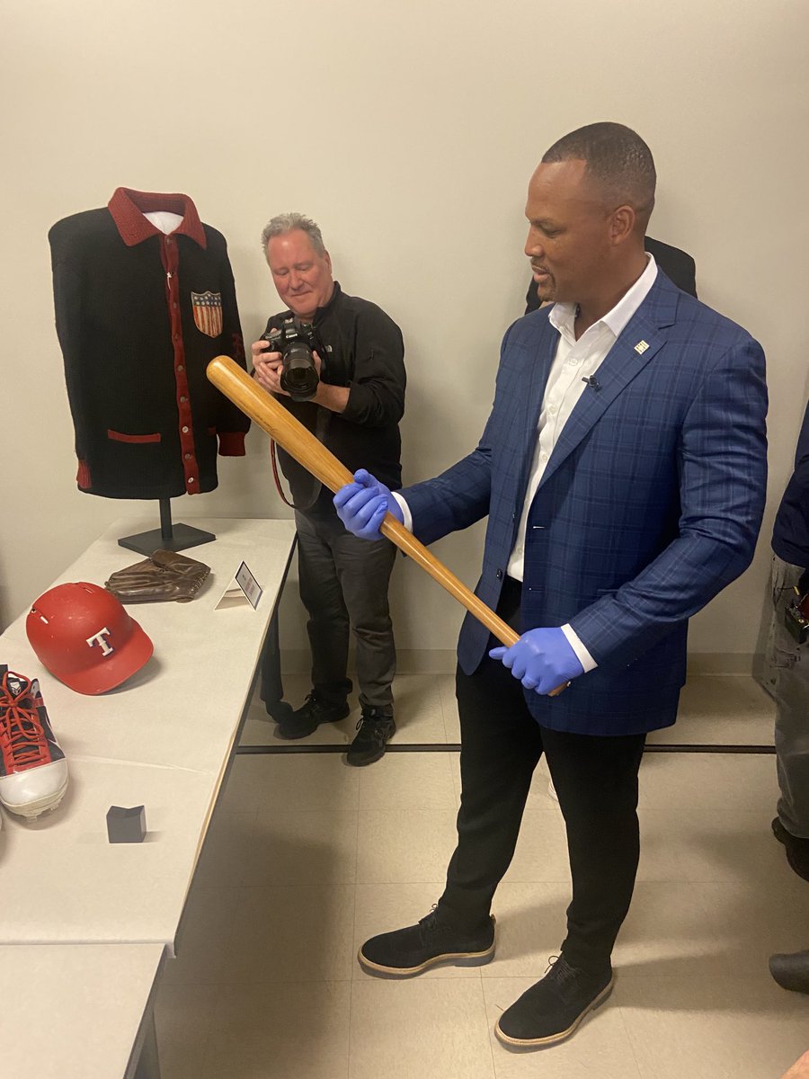 Adrian Beltre holds Babe Ruth’s bat during his tour of the Hall of Fame archives.