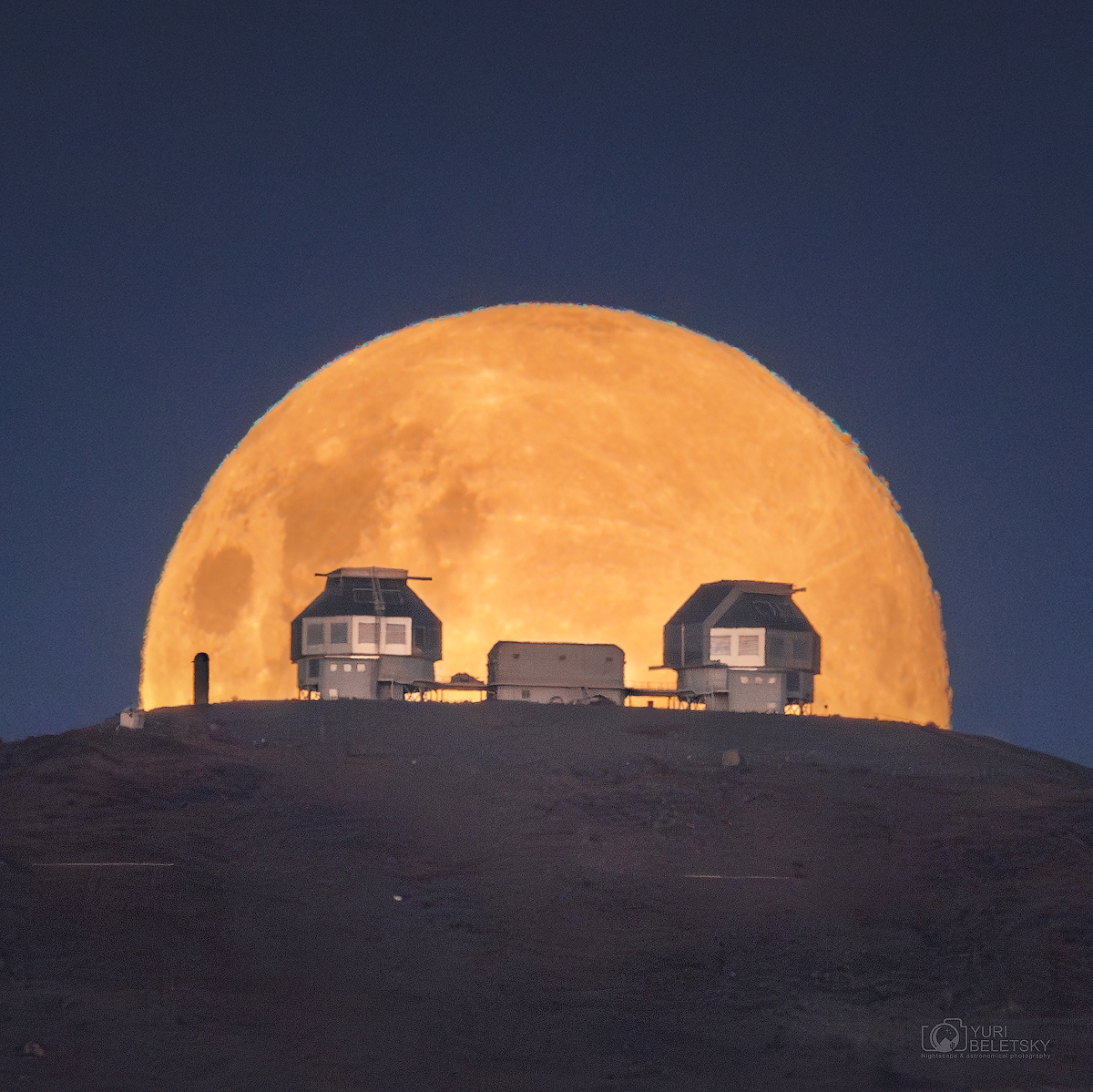 YBeletsky's tweet photo. The 'Wolf Moon' over the 6.5-m Magellan telescope in #Atacama #desert in #Chile. To get to the imaging location we had to drive quite a bit in a 4x4 truck through the rugged desert terrain. But the view was absolutely worth it ! The Moon appeared just behind the telescopes exactly according to the calculations. #Moon #WolfMoon #astronomy #astrophotography #LifeAtLCO #Andes #mountains #fullmoon