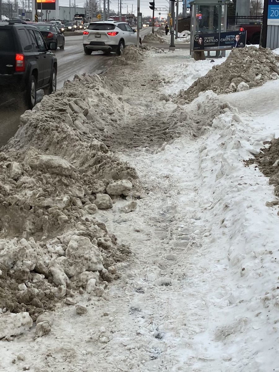 The east sidewalk on McPhillips at Jarvis. Not sure how anyone, never mind those with mobility issues, can traverse this abomination. Road is clear though. ⁦<a href="/cityofwinnipeg/">City of Winnipeg</a>⁩ very clear which type of transportation gets priority.