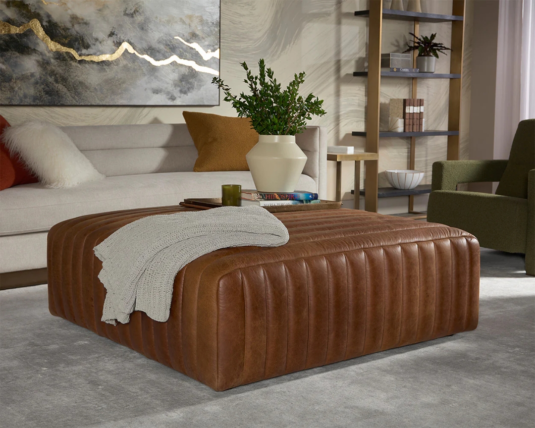 The Lewin Ottoman is a study in texture and dimension. Luxuriously upholstered in our aged cognac Italian leather with vertical channel tufting throughout the entire piece.