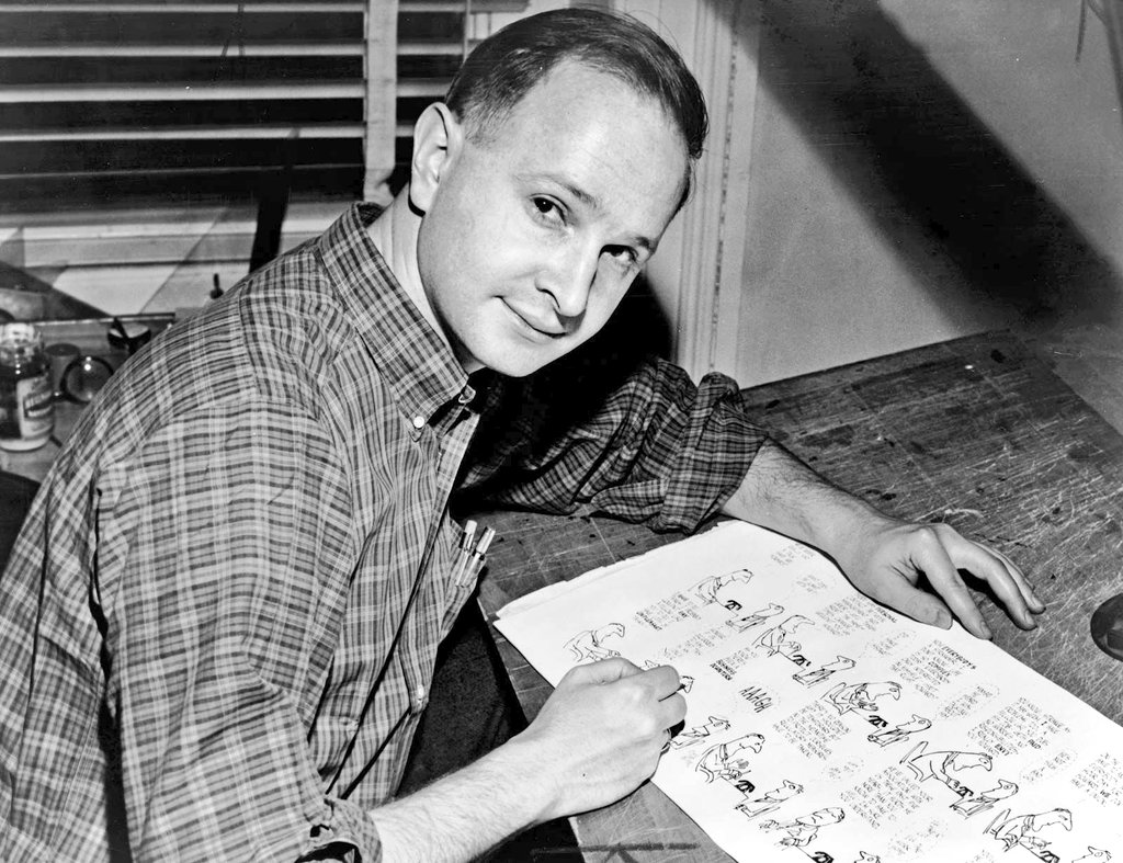 Jules Feiffer, de joven junto a una de sus paginas de humor grafico