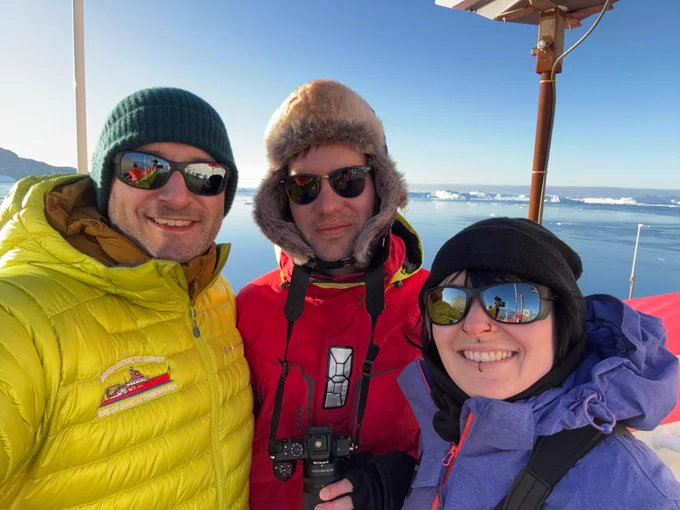 Leeds researchers Will Homoky, Alistair Lough and Chiara Krewer on board the RSS David Attenborough on a sunny day, with the Antarctic peninsula in the background.