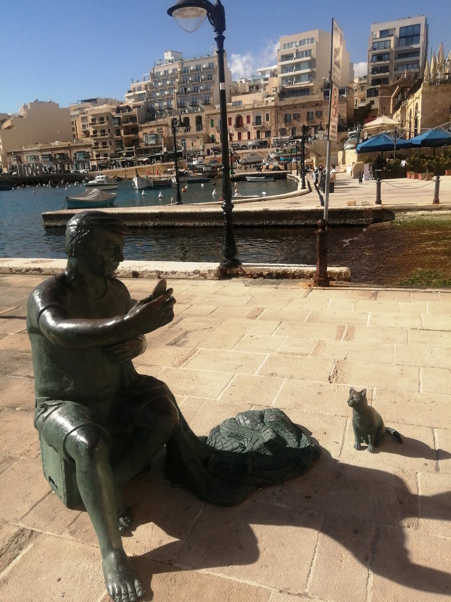 The fisherman and the cat - a perfectly sculptured partnership.