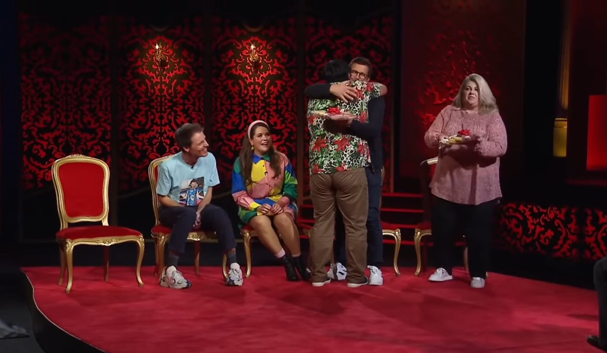 Demonlighter's tweet image. David giving Urzila and Matt presents because he felt guilty after making a diss track about them was the cutest thing ever. Series 2 of #TaskmasterNZ is that bitch 🥳