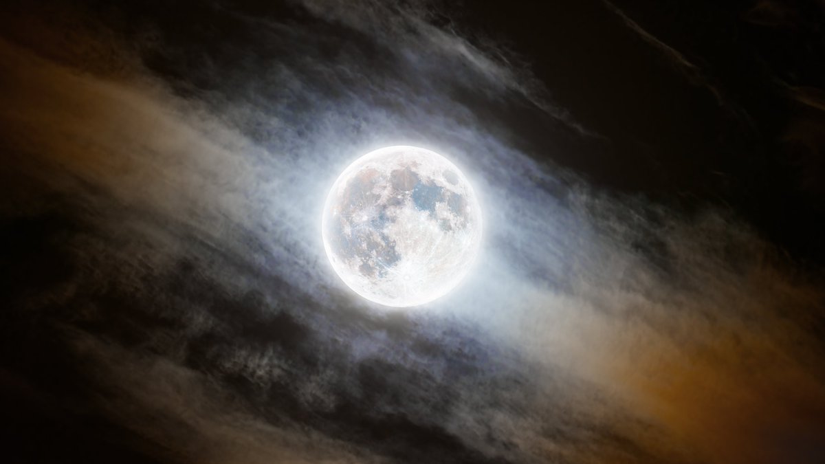 I almost missed my first full moon in over 3 years, but luck was on my side last night. Here's the 2024 Wolf moon just as it cut through thin clouds- creating the illusion that the moon is in the foreground. The light scattered by the clouds creates a beautiful array of color.