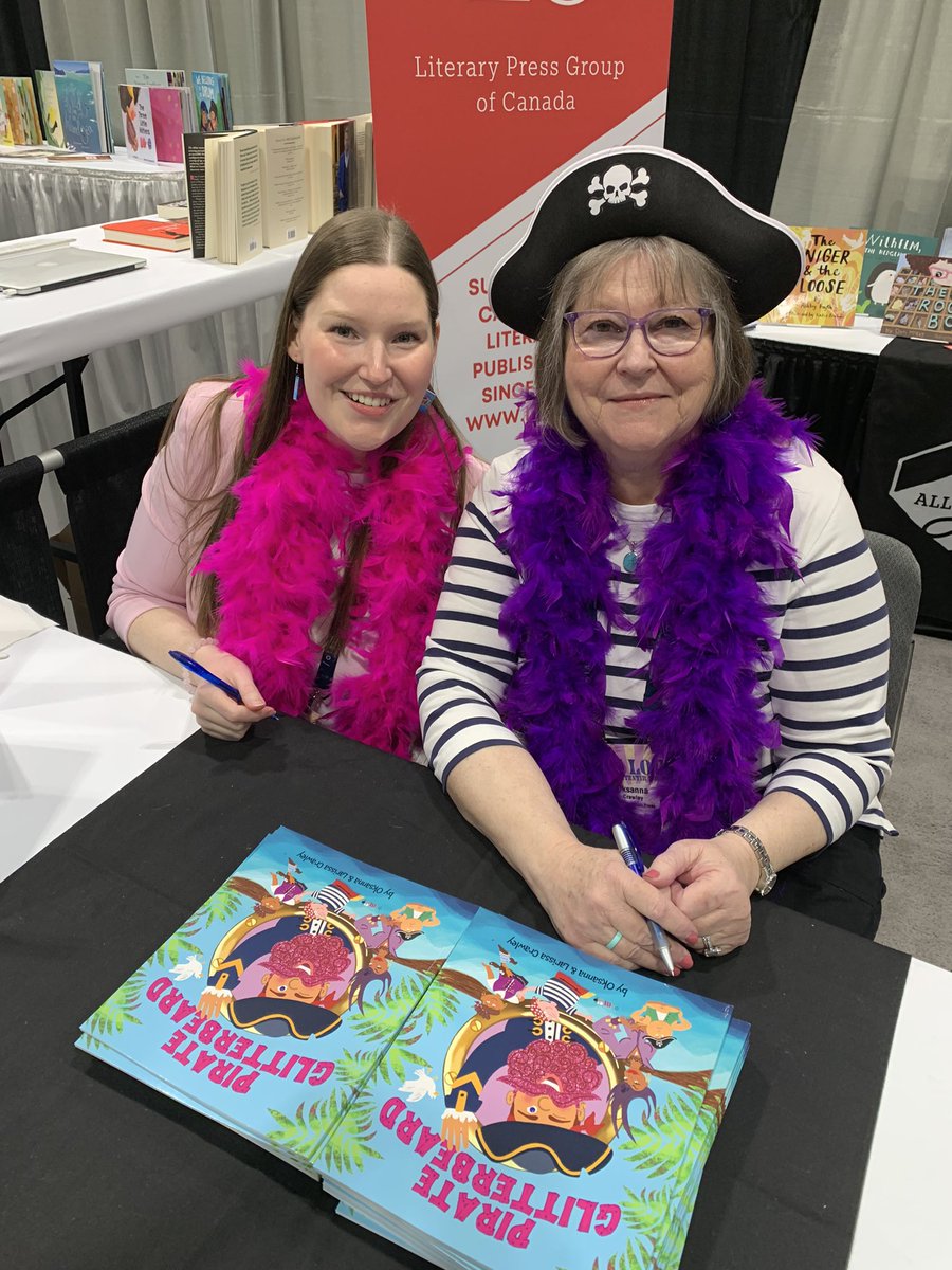 Mother-daughter team Oksanna and Larissa Crawley sign PIRATE GLITTERBEARD (@rebelmountain1) at our booth #olasc2024
