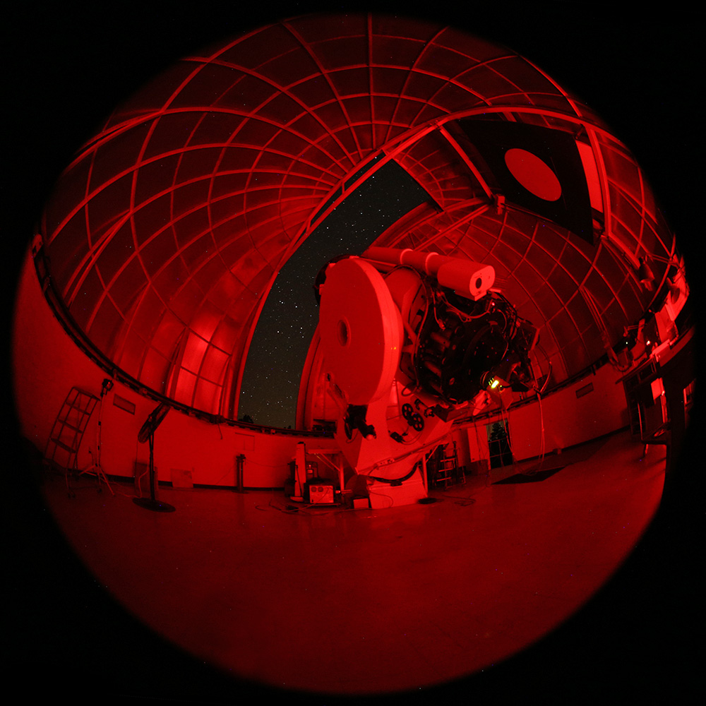 360 image of the inside of an observatory lit up with red light. 
