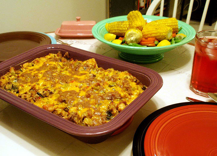 King Ranch chicken (Texas)––a Tex-Mex casserole usually consisting of canned diced tomatoes with green chiles, cream of mushroom soup, cream of chicken soup, diced bell pepper, onion, and chicken topped with cheese. The bottom is lined with corn tortillas or tortilla chips