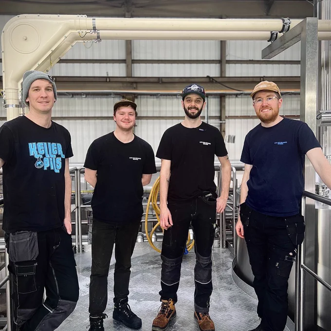 Some of our brewing crew standing on a platform at our brewery