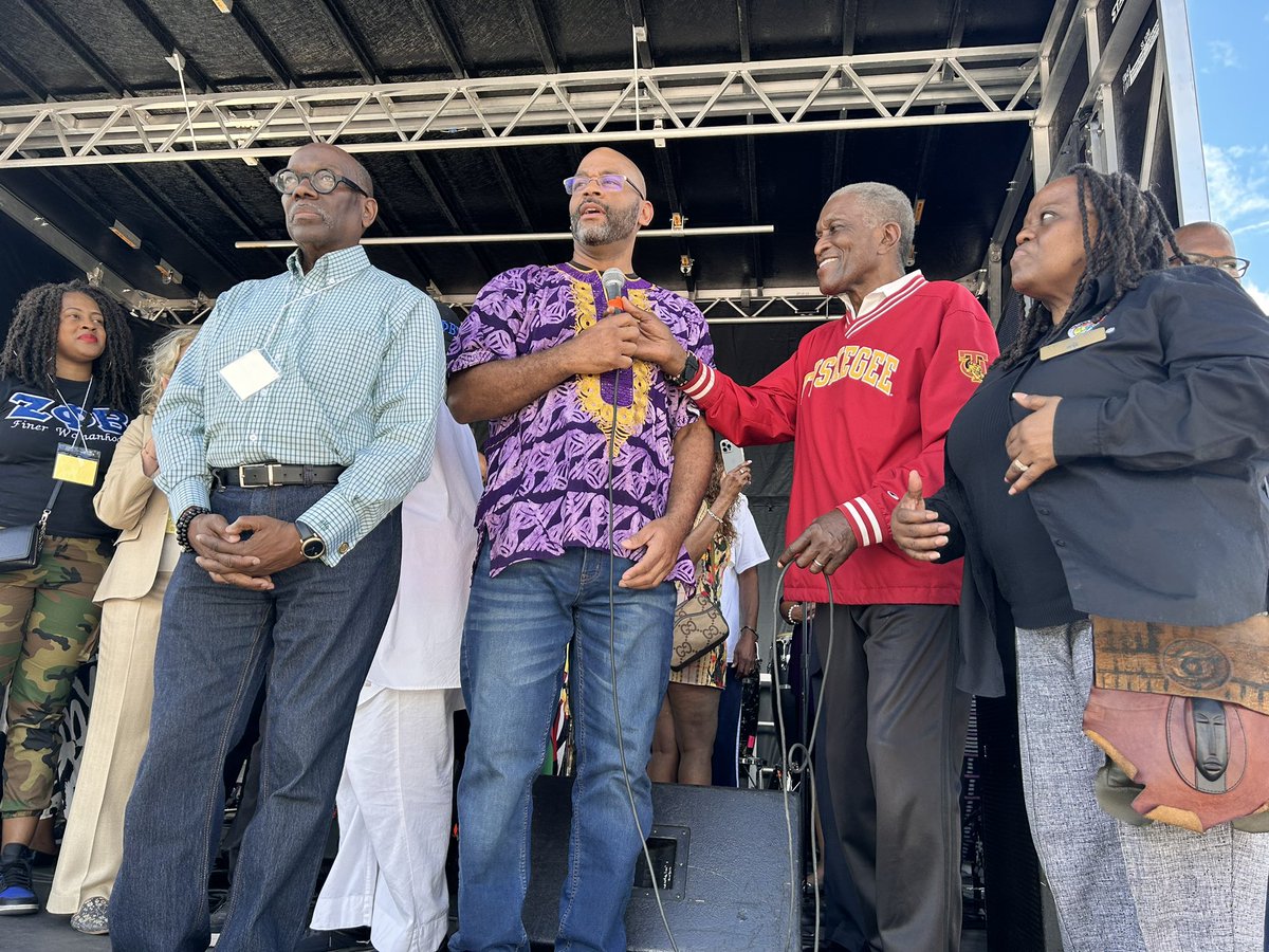 Black town leaders on stage opening up Zorafest.