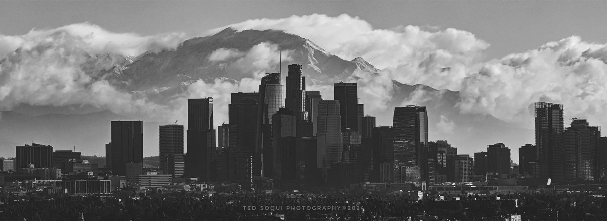Black and white photo this morning of downtown LA with the mighty snow covered San Gabriel Mountain range behind. #LArain #snow #losangeles #weather #winter