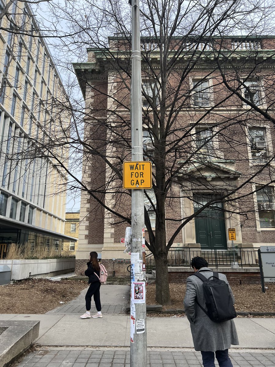 X_EricZhao's tweet photo. The most ridiculous sign I can find, pedestrians are asked to wait for gaps at an intersection ON A UNIVERSITY CAMPUS!!!!
@cityoftoronto @UofT 
Students should have access to high walkability paths on UofT campus and St. George st should NOT be used for through traffic! https://t.co/kUWHs9t35B