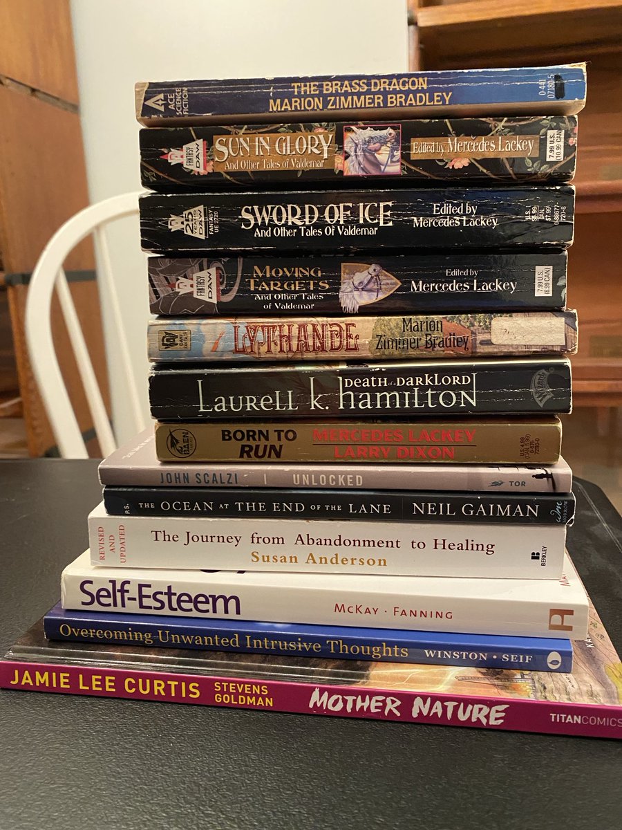 SuprmomcatCathy's tweet photo. Treated myself to my favorite bookstore & came home with a haul for work & pleasure!! (Photo of 13 books stacked on a black table with an empty bookcase in the background by classic & new authors of SciFi, Fantasy & self-help). #UseAltText #Books #Reading #Selfcare https://t.co/jlCFq77S8t