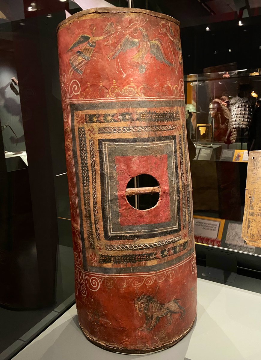 Great to see the only known surviving example of a Roman legionary scutum, on display in London. Made of wood with painted rawhide depicting an eagle with a laurel wreath, winged Victories & a lion, excavated from Dura-Europos in the 1930’s. #LegionExhibition #FindsFriday