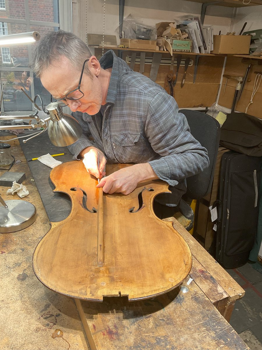 It’s a hive of industry in the workspace at the moment. Steve is trying to find a rattle on a cello he is setting up, Keisuke is fixing a crack on a peg box, Ed is fixing the bridge on a customer’s violin and Gary has just taken off the top of a student bass #lutherie #craft