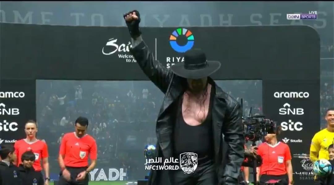 mhossamy26's tweet photo. Undertaker revealing the cup at a final match which Cristiano Ronaldo is playing in Saudi Arabia!! Are we drunk? https://t.co/smznotDZpM
