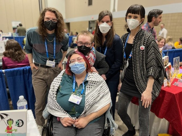 Look at our lovely SLM staff and contribs! Come hang out at T3105 at #AWP24 and pick up some merch 💗