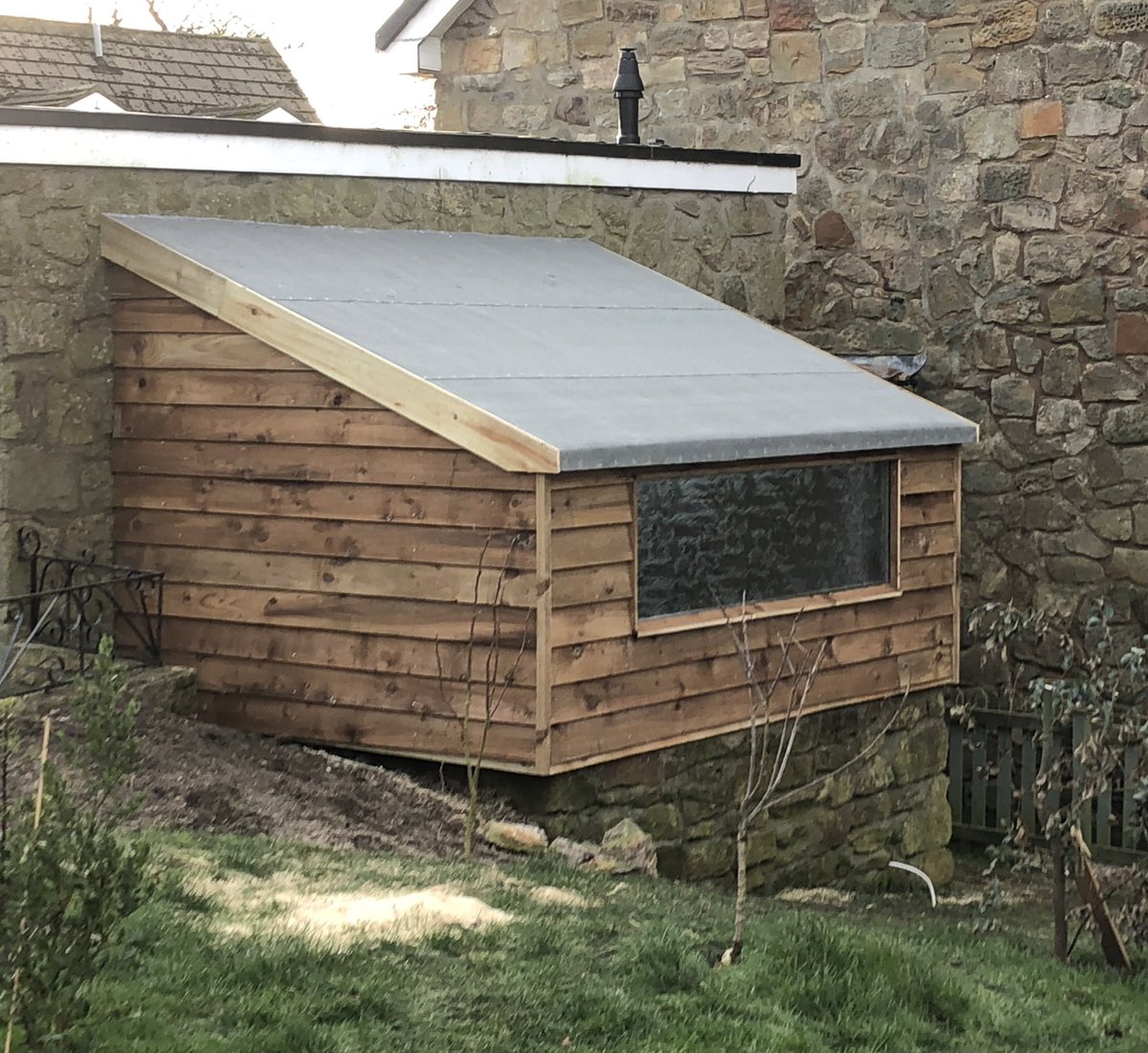 Disused oil tank storage area converted into a handy garden shed.