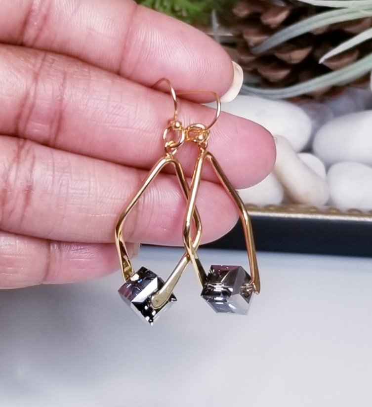 These enchanting earrings were made to add a chic look to any style. The Eden earrings feature Swarovski light Chrome crystals attached to a gold-tone loop. #sandalomadesigns #swarovskicrystals #wearsandaloma #jewelry #fashion #Jewellery #earrings #handmade #accessories