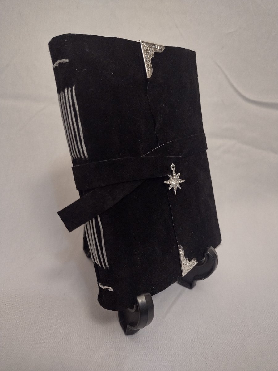 I love the sleek elegant look of this black leather coupled with the star charm! 
Leatherbound journal in Long Stitch style with a dyed pigskin leather cover, and tea stained pages. Pages are not lined. 

#art #handboundjounral #leatherjounral #bookarts #bookartist #bookbinding