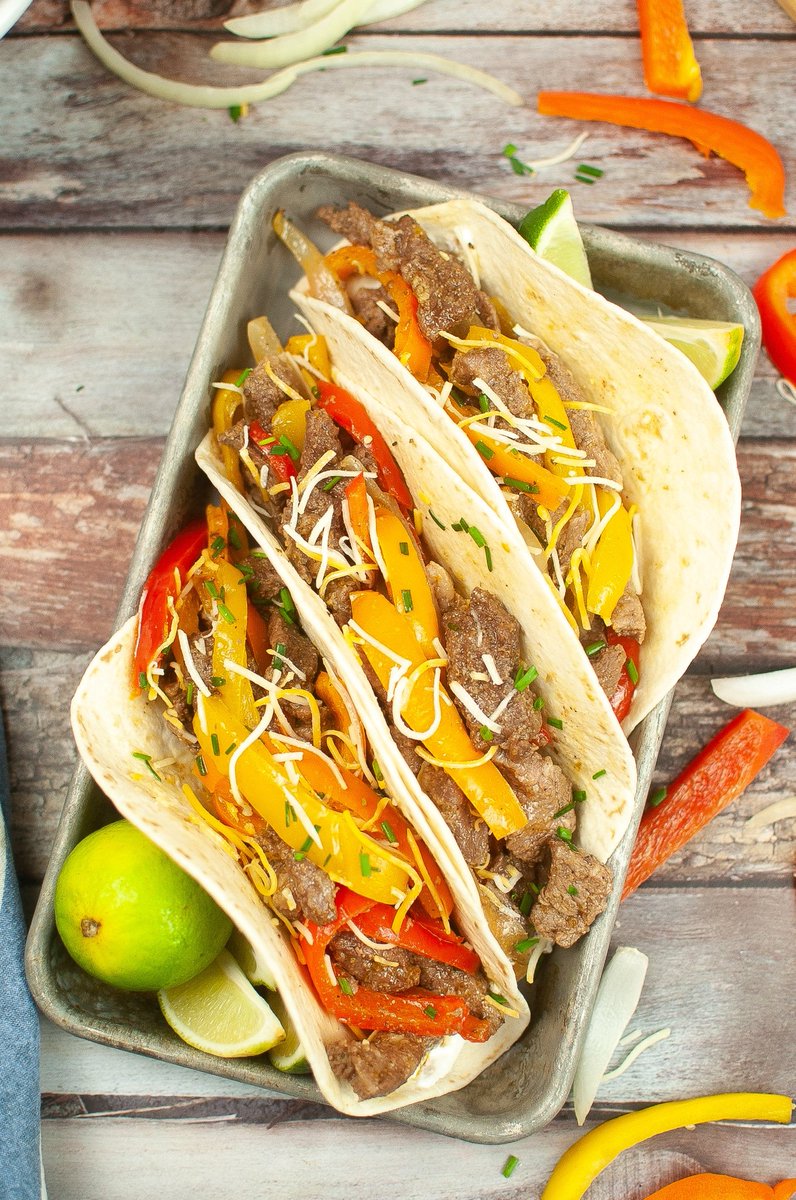 Have a delicious family dinner on the table in only 30-minutes with this Easy Sheet Pan Steak Fajitas recipe! Flank steak combines with fresh bell peppers and onions for a fan-favorite meal cooked all in one pan.  thriftyjinxy.com/easy-sheet-pan…
