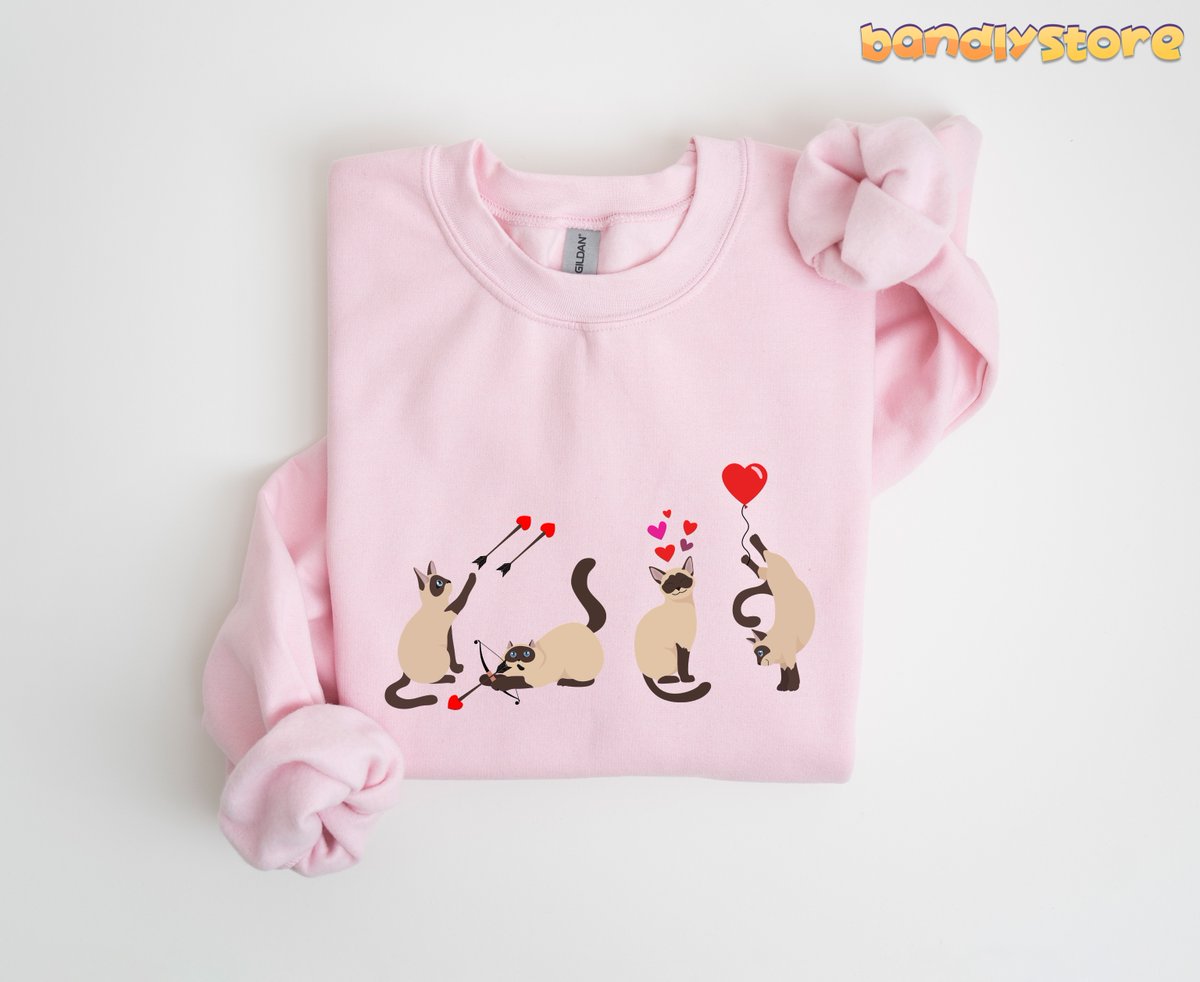 bandlystore's tweet photo. Celebrate Valentine's Day in style with our adorable Siamese Cat Sweatshirt!

https://t.co/eQ3mSI1pew

#SiameseCatGift #SiameseCatCrewneck #SiameseCatSweater #ValentinesDayShirt #CatMomSweatshirt #CatDadSweatshirt #ValentinesDayGift #SiameseCatLover #SiameseSweatshirt https://t.co/CJV7mWgzED