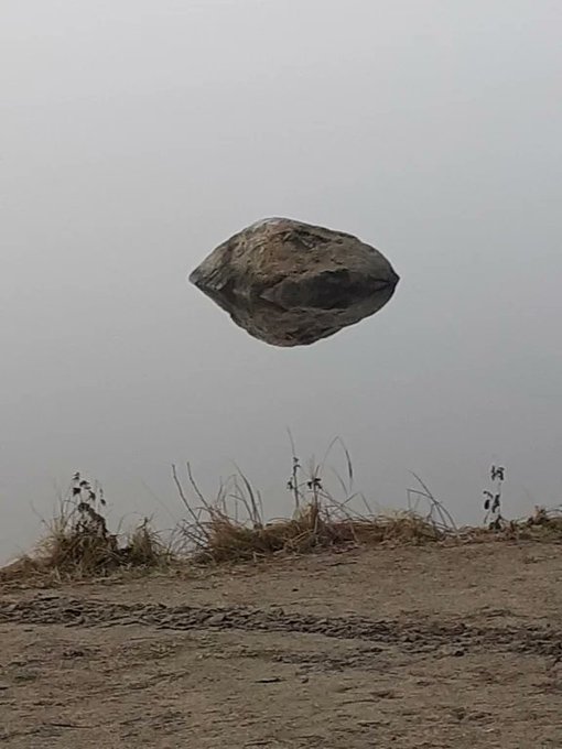 This photo is an example of how optical illusions mess with your mind. 

First you see a rock floating in the air and then...