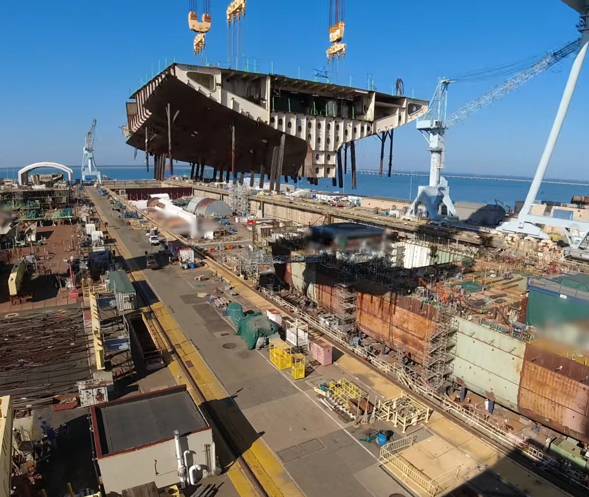 Aft section of U.S.S. Enterprise (CVN-80) lifted and placed into dry dock,  October 2023.