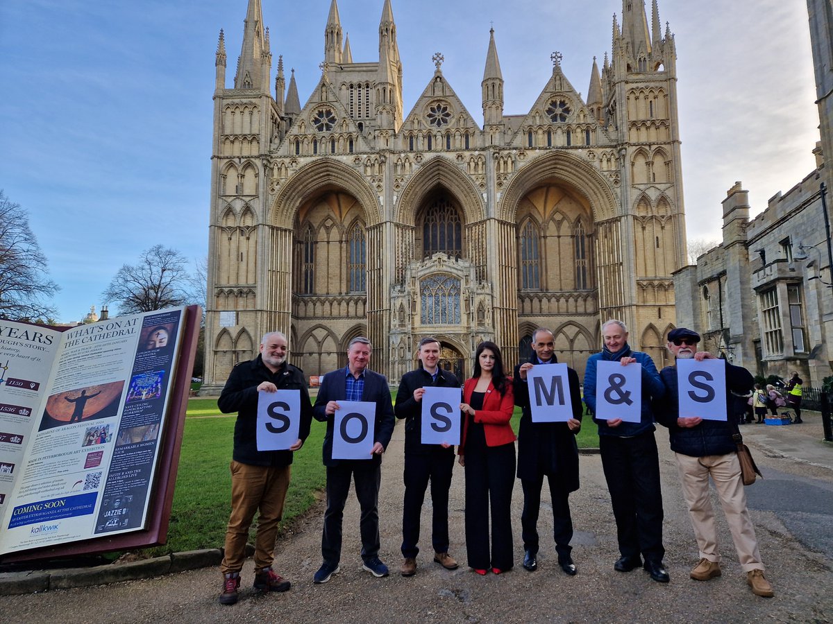 'SOS M&amp;S': Politicians and civic leaders met outside Peterborough's stunning cathedral this morning to call on retailer to stay in the city centre

Council leader Mohammed Farooq says talks with the company are ongoing