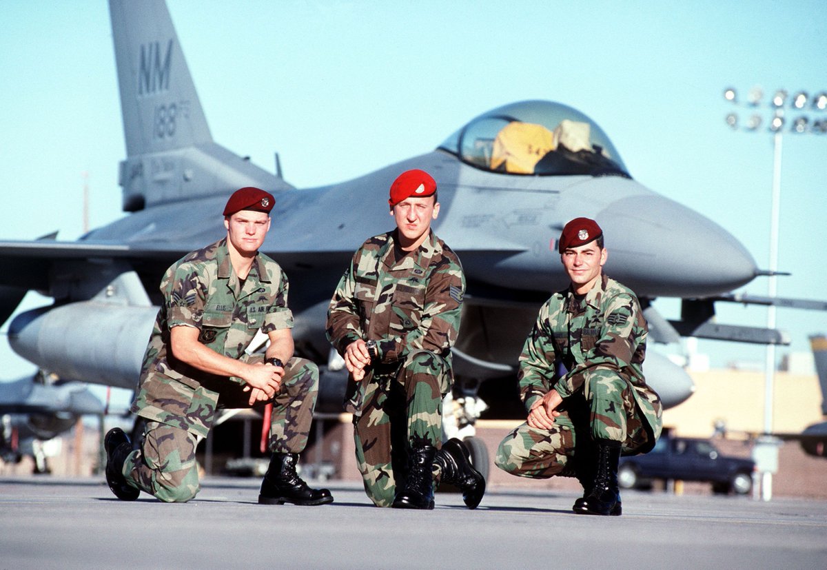 USAF SSgt Jeremy Hardy (right), a #pararescueman, USAF SrA Ron Ellis (left) and USAF Sgt Andy Kubik (center), a #CombatController, members of a rescue team, pose in front of an F-16 Fighting Falcon aircraft at #HurlburtField, Florida. February 2000 Airman Magazine.